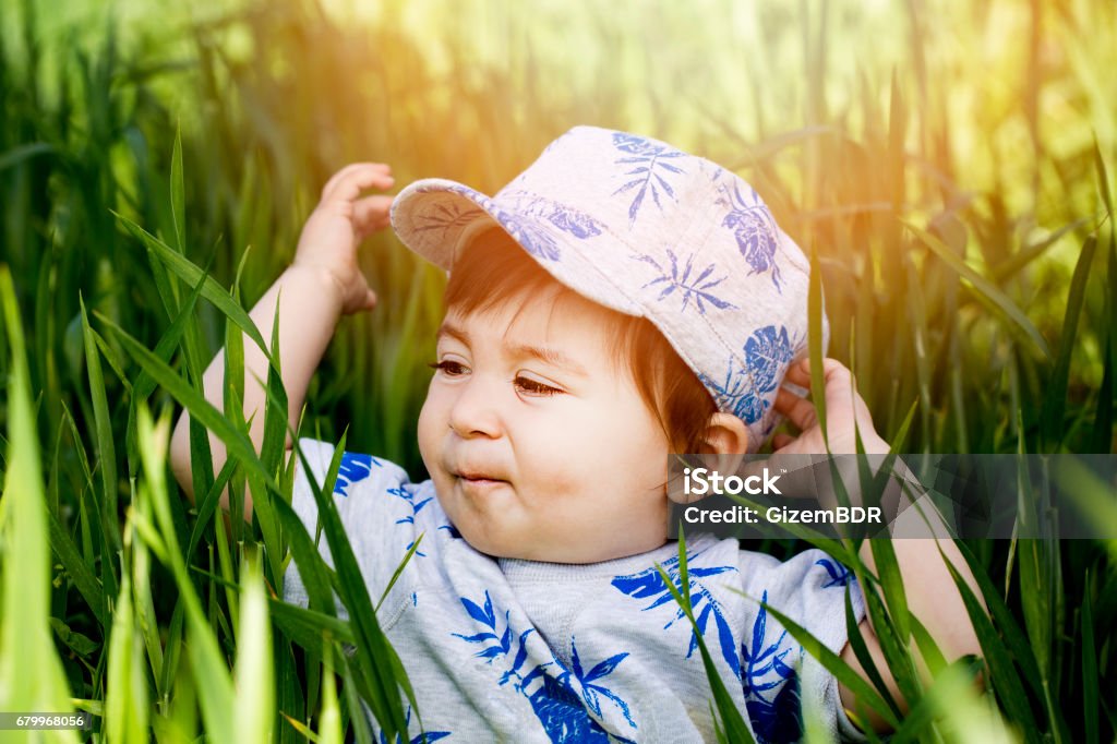 Young boy doing a headstand on the grass